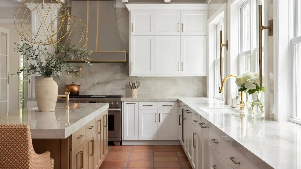 Luxury kitchen featuring white shaker cabinets, marble countertops, and durable solid brass hardware handles.