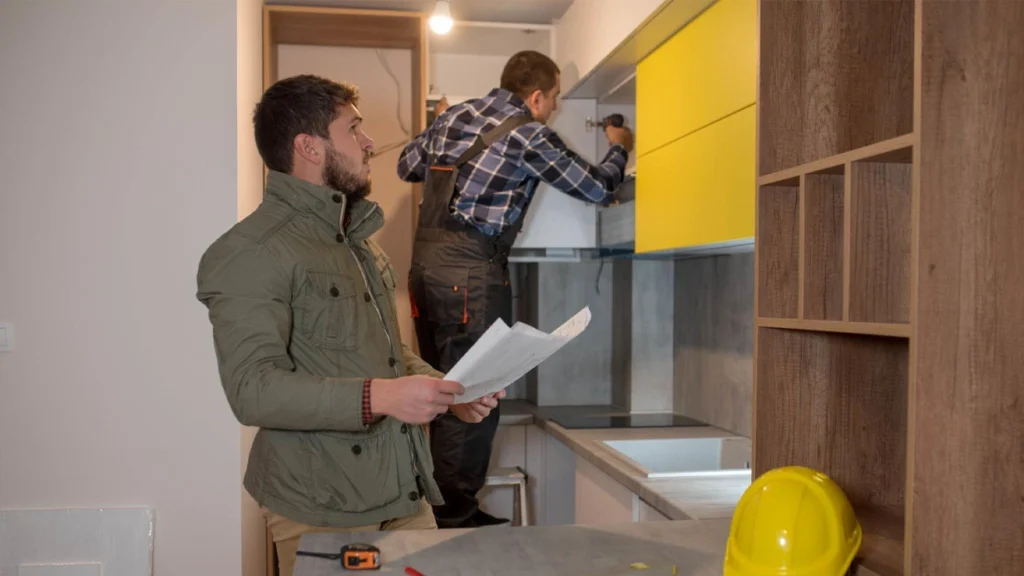 Checking a matte white lacquer custom cabinet door against a numbered packing list for a luxury apartment kitchen project.
