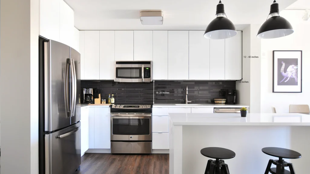 White modern kitchen with dimension lines showing 12-42 inches cabinet height and an 18-20 inches countertop gap.