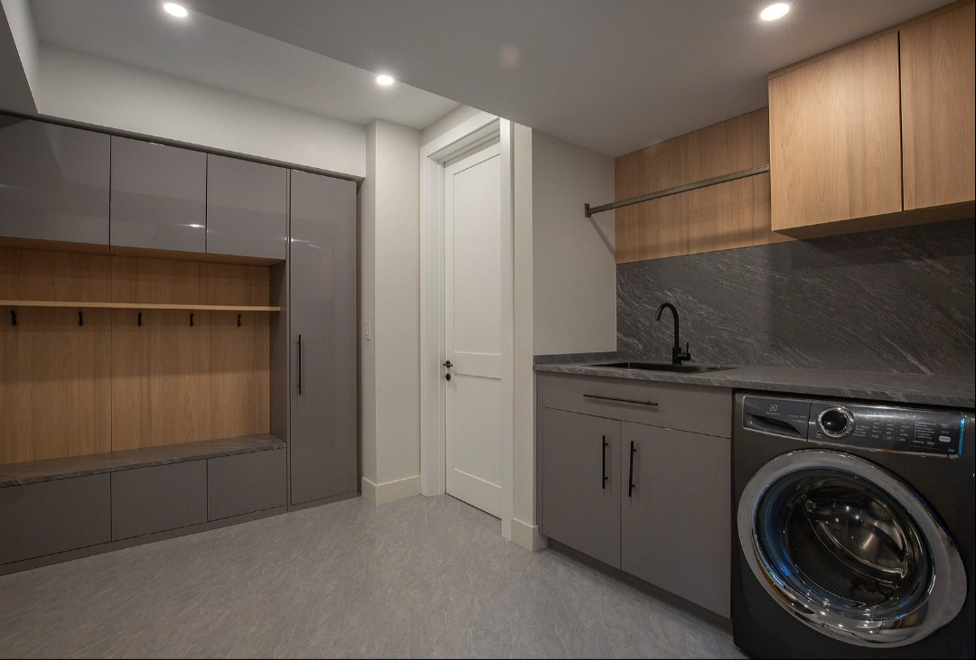 Practical laundry and utility room with custom cabinets and durable surfaces