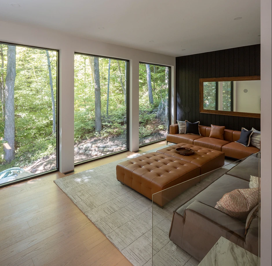 Relaxed lounge and family room with large windows and warm flooring