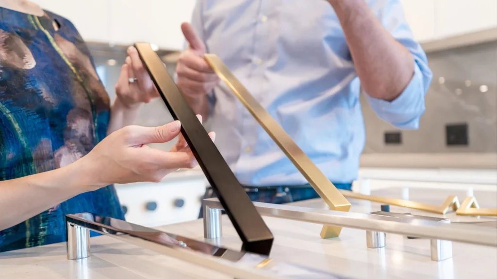 Hotel project buyers reviewing custom kitchen cabinet hardware pulls in matte black and brushed gold finishes.