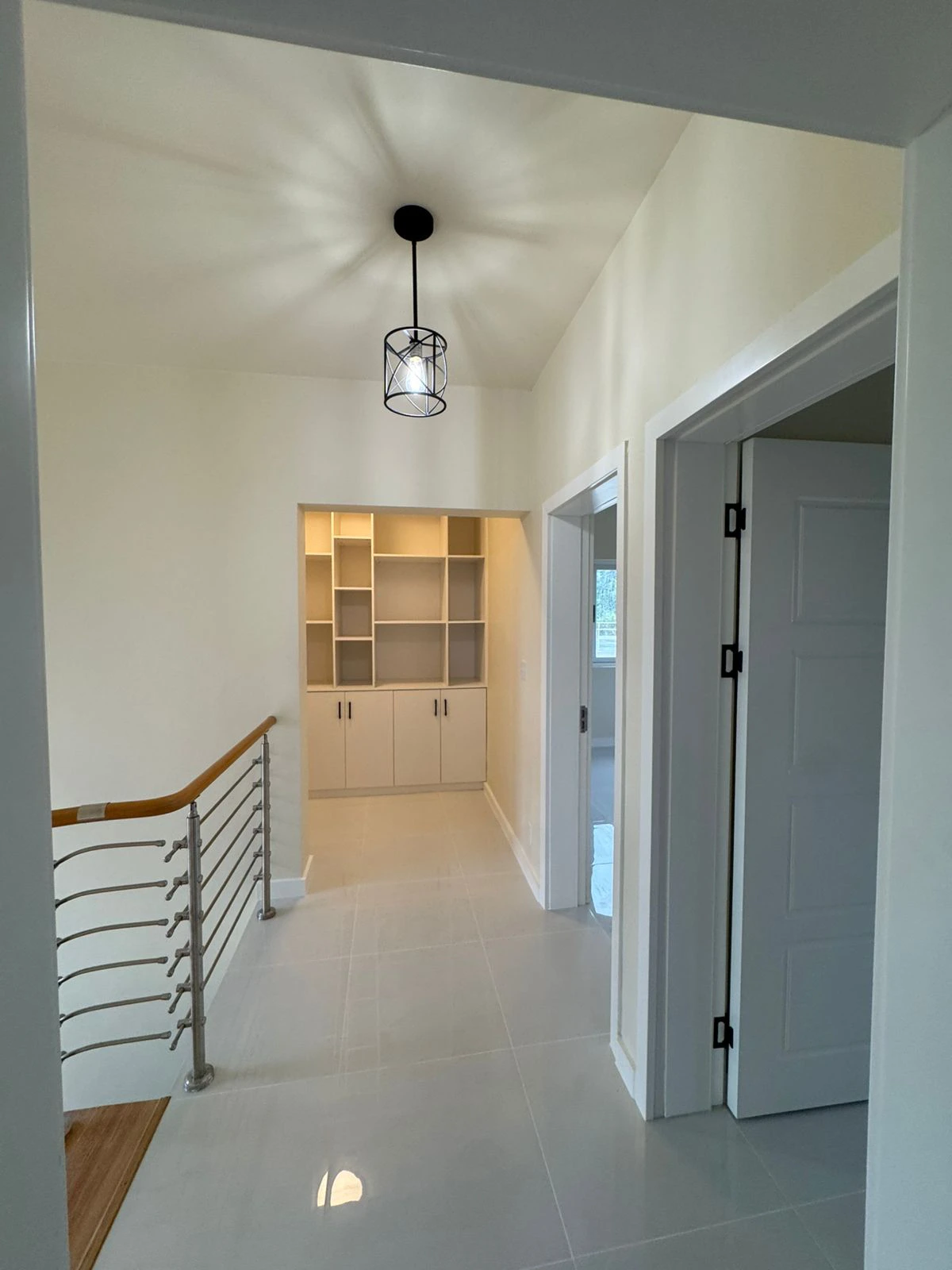 Guam Villa simple base tile design across kitchen and hallway