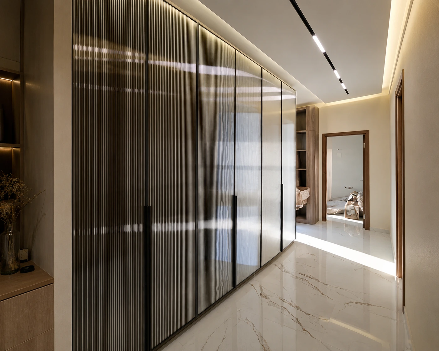 Full-height custom wardrobes and ribbed glass display shelves for bedrooms