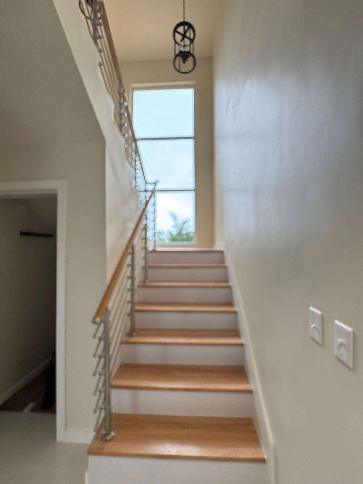 Guam Villa staircase with warm wood-tone treads and white risers