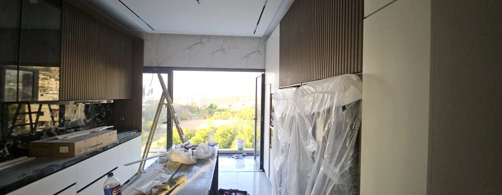 Dark stone countertop and matching backsplash in Lebanon villa kitchen