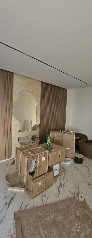 Living area feature wall with wood slat panels and built-in storage