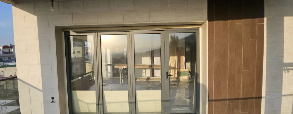 Villa balcony with large openings and open hillside view