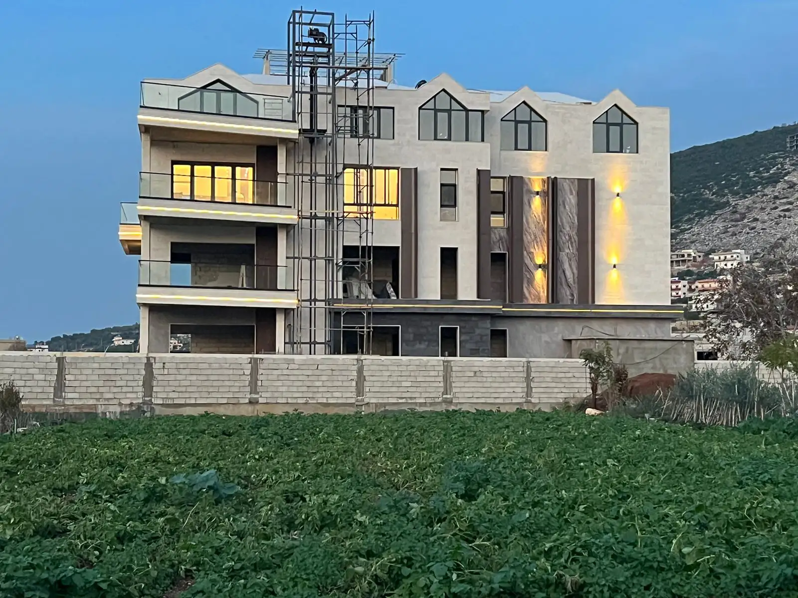 Glass railings and dark frame window system on Lebanon villa balcony